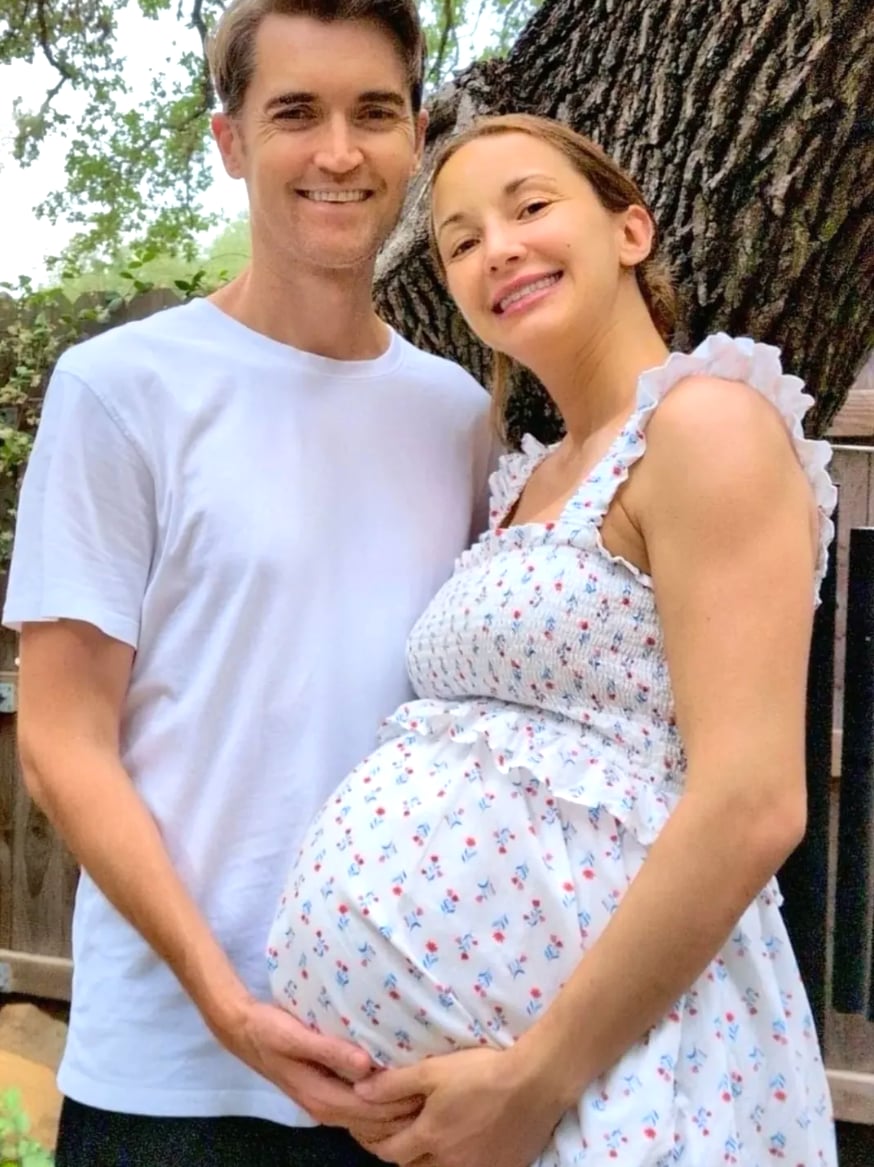 Ross Ulbricht and his pregnant wife standing together outdoors under a tree, both smiling, his hands on her belly.